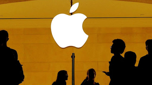 Customers walk past an Apple logo inside of an Apple store at Grand Central Station